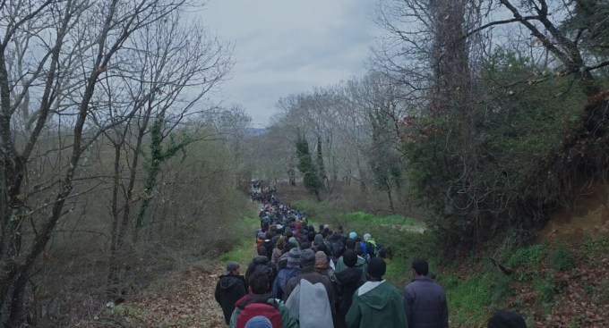 Refugees walking near Idomeni Camp, Greece in HUMAN FLOW, an Amazon Studios release. Photo courtesy of Amazon Studios.